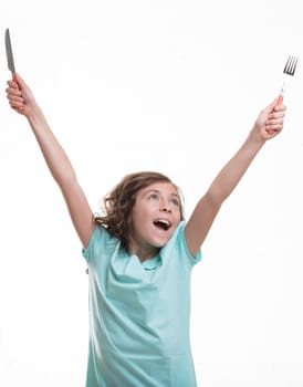 ittle girl in blue shirt, arms raised holding cutlery, celebrates mealtime. She can eat anything and still stay slim!