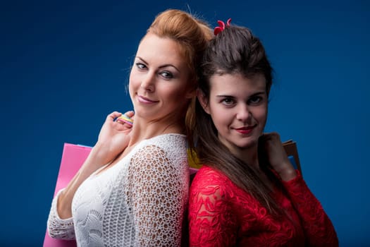 Back-to-back shoppers exude cheer, their shopping success displayed in vivid bags