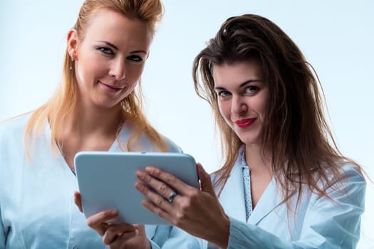 Professional exchange between two doctors reviewing medical information on a portable screen