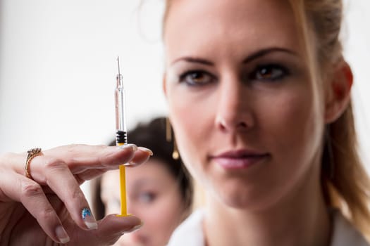 Detailed preparation of a medical injection, causing distress to an onlooking person