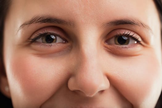 Eyelashes frame the womans eyes, highlighting their depth and the stories they might tell