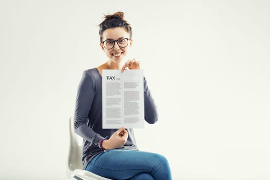 Portraying a positive approach to taxes, she holds the document, dispelling the myth of tax-time anxiety