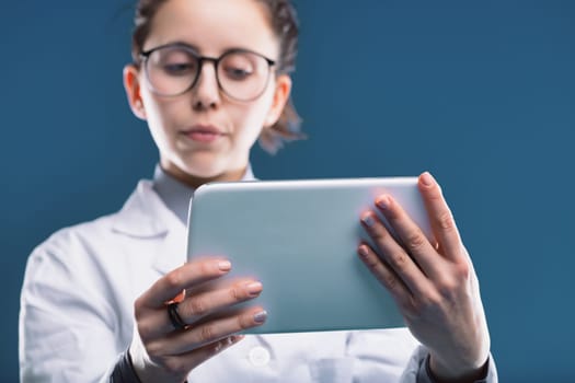 The focused medic uses a digital device to access patient information, demonstrating modern healthcare