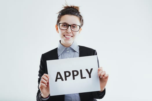 enthusiastic woman communicates an open invitation to apply, suggesting opportunities for career advancement