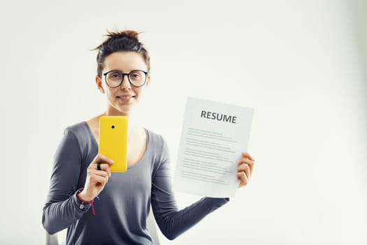 With a resume in one hand and a phone in the other, she's well-equipped for the digital age of employment