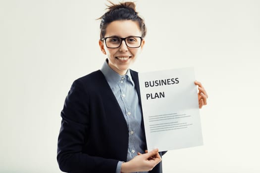 aspiring entrepreneur beams with confidence as she presents a meticulously crafted business plan