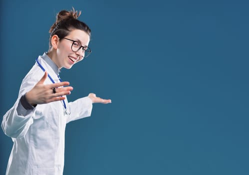 Energetic medical professional gestures openly, her lively expression inviting engagement. Come on, enter.
