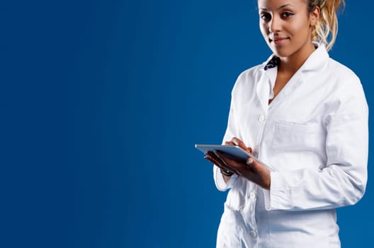 Skilled brown-skinned researcher using a tablet expert in big data, statistics. Doesn't get misled by superficial beliefs, strengthens science