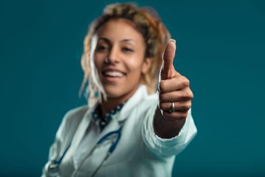 With a bright smile and a positive sign, she embodies the cheerful spirit of healthcare