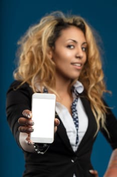 young businesswoman showcases a smartphone, her bright smile reflecting the ease of modern technology