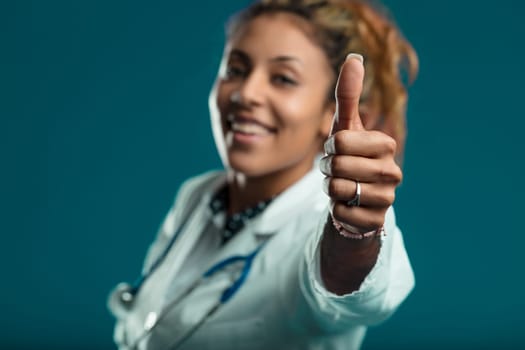 medical professional's thumbs-up gesture exudes optimism and success in her field