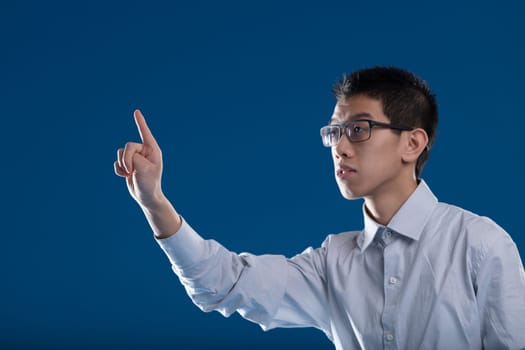 Man typing in the air, his fingertip in sharp focus. Ideal for your extra graphics and COPYSPACE. Interaction with AIs and neural interfaces in the metaverse