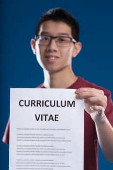 East Asian man showcasing a resume, inviting you to apply at his satisfying workplace, or offering his expertise to solve your organization's issues. Responding to the 'great resignation' with judicio