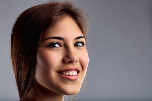 Casual yet composed, the young womans portrait exudes a sense of openness and approachability