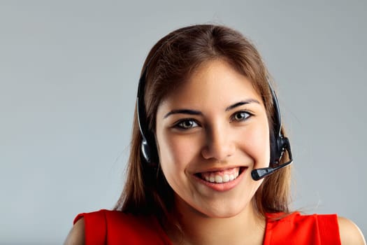 Enthusiastic support agent smiles warmly, her headset suggesting a conversation in progress