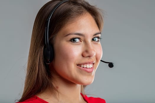 Young telephone assistant patiently and politely listens to the customer's request before responding. Will offer her helpdesk with the usual competence and professionalism of when you contact us