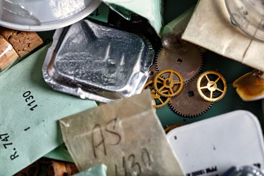 Watches, gears, springs and metal mechanisms, paired with jewellery and wood on an artisan's table. This artful blend of craftmanship in horology combines function and aesthetics
