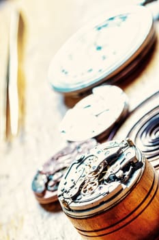 Layers of watch faces reveal the beauty of time's architecture, resting on a wooden bench