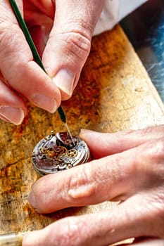 master at work, delicately maneuvering through the intricate dance of watch assembly