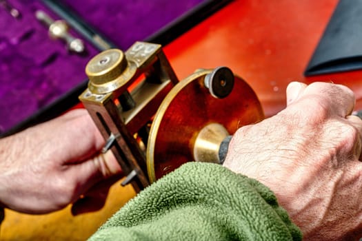 Artisan at work in a steampunk and old-style fashioned environment. Detailed focus on watches, gears, springs. Craftsmanship in horology is art, skill, a blend of utility and ornamentation