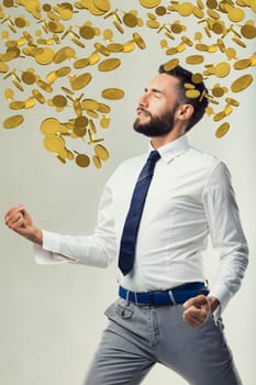 Businessman enjoys a metaphorical financial windfall, symbolized by raining money