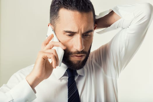 Determined executive fields a critical call, his intense focus suggesting high-stakes decision-making