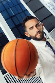 Confident professional uses basketball to represent the importance of precision and teamwork in business