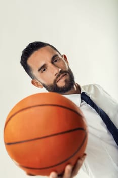 Corporate athlete merges competitive spirit with professional poise, holding a basketball in office attire