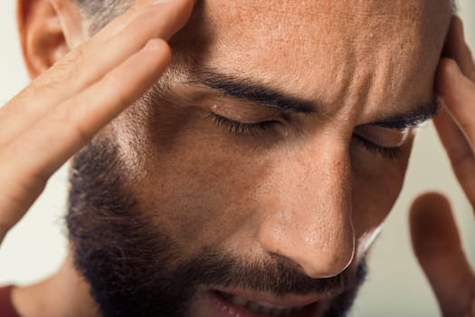 Distressed individual appears to suffer from a headache or intense concern