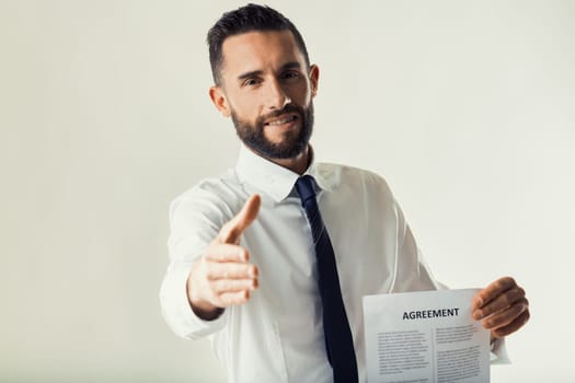 Professional man presents an agreement with a serious, persuasive demeanor