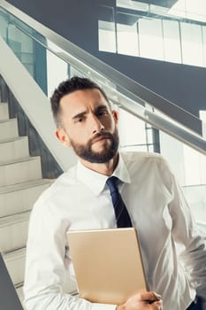 Confident professional holds his work documents, prepared for a strategic meeting