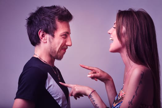 Playful taps on her boyfriend's chest, a young woman's childlike teasing brims with love. He tolerantly accepts, their mutual respect evident. This lively scene hints at forthcoming emotional, laughte