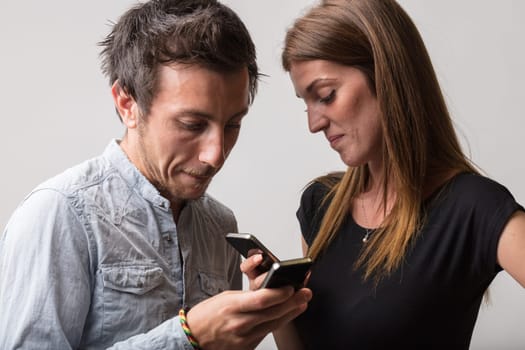 Despite their proximity, a man and woman ignore each other, absorbed in their phone screens. They lose the chance for meaningful dialogue and physical connection, existing merely as physical presences