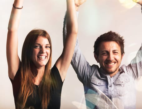 Exulting in a victory, a man and woman laugh and shout with joy, arms raised. They celebrate a fortunate moment, an explosion of happiness and peak positivity, embodying the joy of life. Yes!!!