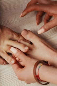Overhead shot: woman's pink-polished toes seek to intertwine with man's, symbolizing romantic union and caring touch. Concept of self-care, cuddles, affection