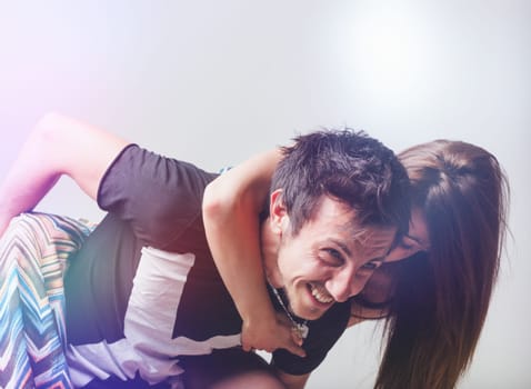 Young lovers play in a roughly physical way, laughing and clinging to each other, climbing, and embracing with all their body weight. They're grown men and women, yet remember what it means to play as