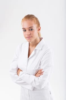 Young female researcher or scientist in a white lab coat, with blonde hair and blue eyes, hoping to contribute to improving the world with her dedication, sharing knowledge, gaining insights, and achi