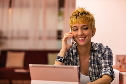 She chats animatedly on the phone, balancing the warmth of conversation with the focus of work