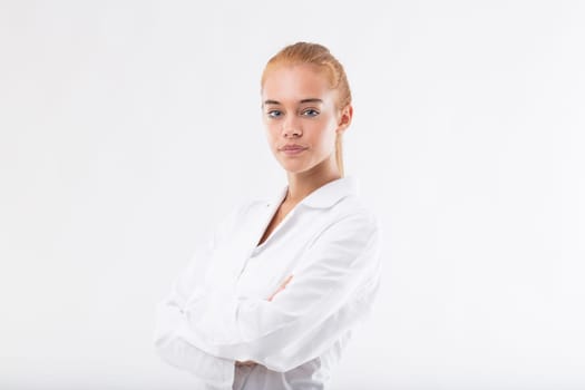 Young female researcher or scientist in a white lab coat, with blonde hair and blue eyes, hoping to contribute to improving the world with her dedication, sharing knowledge, gaining insights, and achi