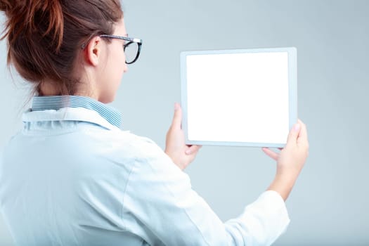 Tech specialist in white coat, critically observing an empty tablet screen. Portrays high-tech, online content, and the analytical aspect of digital consumption