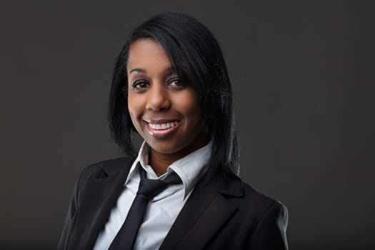 Professional and poised, this woman's warm smile and smart attire suggest a background in corporate settings