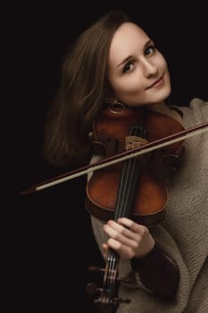 The violin cradled lovingly, this musician's joyful expression captures the artistry and soul of the performance