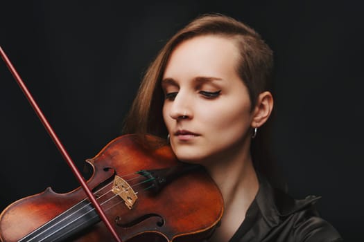 musician with a serene expression plays a Baroque violin, embracing the instrument's rich historical resonance