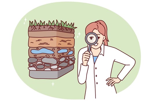 Woman scientist with magnifying glass is engaged in geology in search of deposits of valuable resources. Girl ecologist in white coat conducts examination of soil pollution
