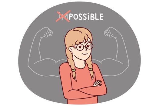 Proud little girl stands with arms crossed near inscription impossible is possible and muscular arms drawn on blackboard. Schoolgirl teenager successfully cope with challenge and gained new knowledge