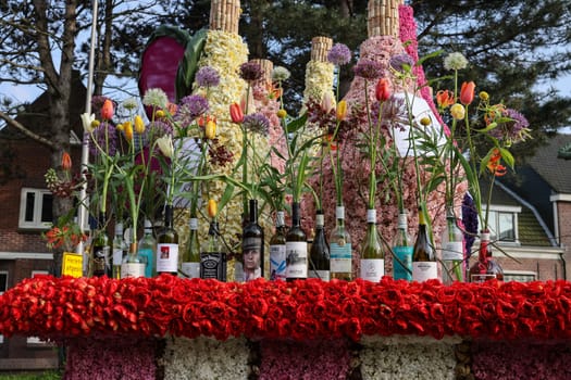Noordwijkerhout, Netherlands - April 21, 2023: Drinks bar made of tulips and hyacinths presented before the evening illuminated Flower Parade Bollenstreek in Noordwijkerhout