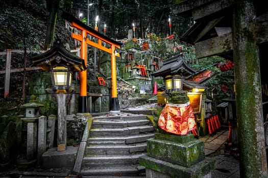 Illuminated lanterns light up the meandering paths and torii gates at fushimi inari shrine, kyoto