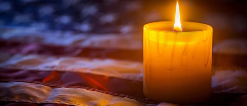 A warm, flickering flame illuminates an American flag-themed candle, evoking a sense of patriotism and reverence for fallen heroes on Memorial Day
