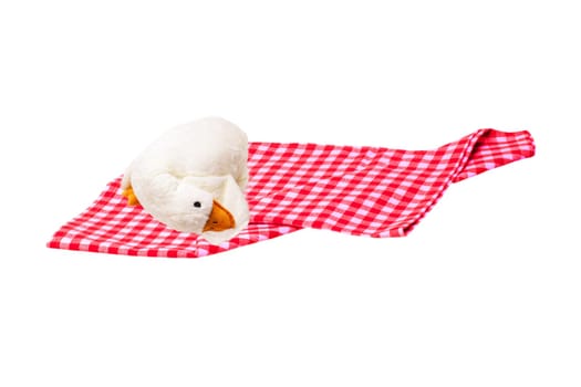 Red picnic cloth. Red checked picnic blanket with a plush toy duck for kids on it isolated on a white background. Copy space.