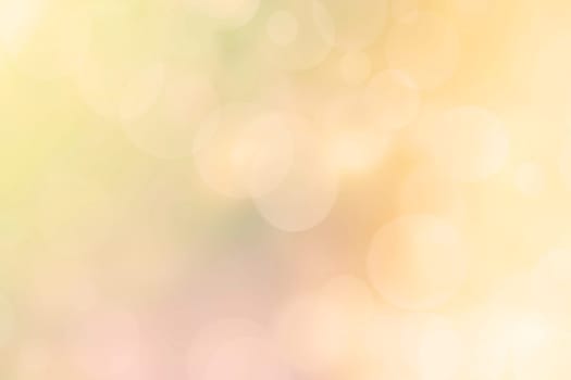 Abstract blurred fresh vivid spring summer light delicate pastel yellow pink orange bokeh background texture with bright circular soft color lights and stars. Beautiful backdrop illustration.